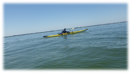 A person in a kayak on the water

Description automatically generated