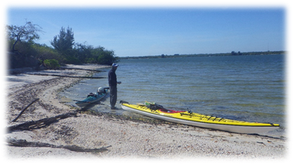 A person standing next to a kayak

Description automatically generated